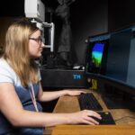 Lauren Garrett, UofL senior bioengineering student, tests one of two new multiphoton confocal microscopes provided to the University of Louisville by the Veterans Health Administration