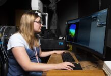 Lauren Garrett, UofL senior bioengineering student, tests one of two new multiphoton confocal microscopes provided to the University of Louisville by the Veterans Health Administration