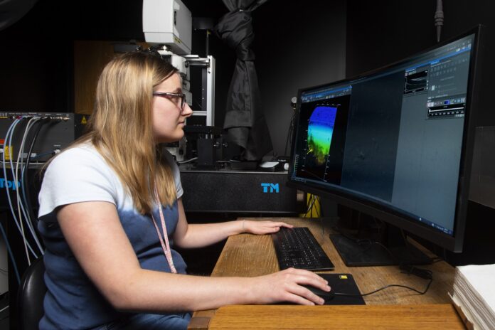 Lauren Garrett, UofL senior bioengineering student, tests one of two new multiphoton confocal microscopes provided to the University of Louisville by the Veterans Health Administration