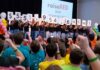 raiseRED participants holding up numbers to reveal the total raised, $551,954.66.