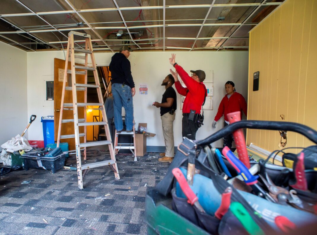 4 men doing construction inside Brodschi Hall