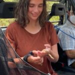 Autumn Magnuson holds a snake during a field study.