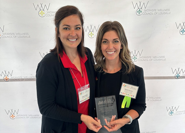 Kristina Doan (left), communications manager for UofL's Office of Human Resources, and Tamara Iacono, wellness coordinator for UofL's Get Healthy Now program, accepted the Silver Worksite Wellness Award on behalf of UofL at the Worksite Wellness Council of Louisville’s annual conference May 24.