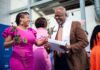 Candice Hardin, Louisville Teacher Residency (LTR) coach at JCPS, hands a rose to LTR graduate Donald Morehead at the graduation celebration on May 18 (photo courtesy JCPS)