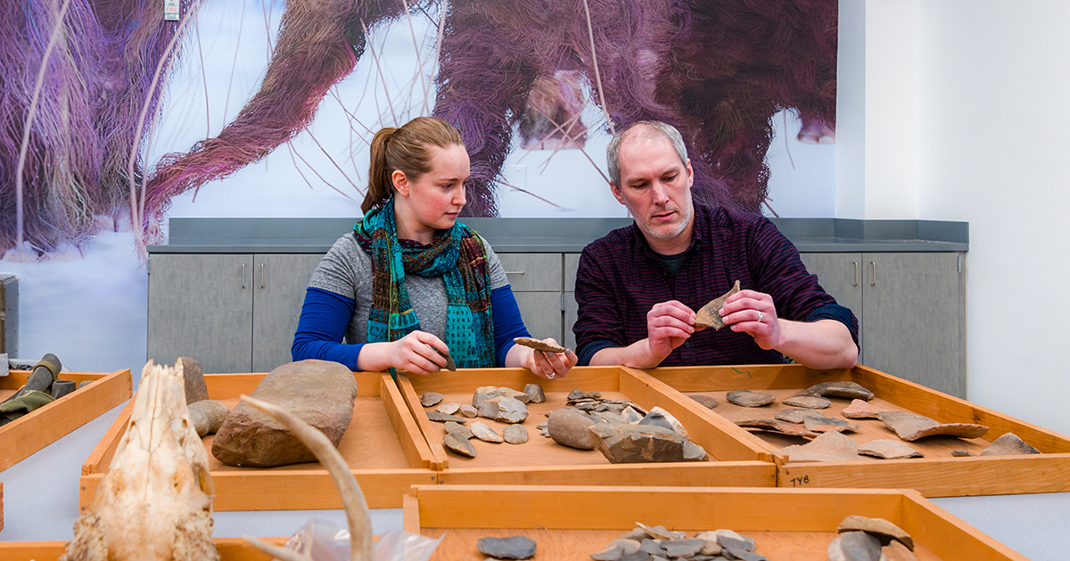 Anthropology faculty and staff examine artifacts