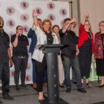 The University Club hospitality team and representatives from UofL toast the grand reopening of the University Club. -Photo by Ron Harrison