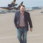 Jeff Wafford walking on runway between UPS planes