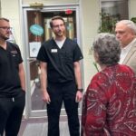 UofL dental students talk with UofL President Kim Schatzel and Kentucky Senate President Robert Stivers, R-Manchester, at Red Bird Dental Clinic.