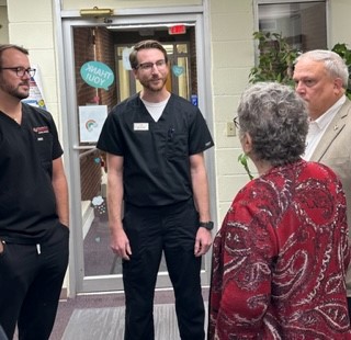 UofL dental students talk with UofL President Kim Schatzel and Kentucky Senate President Robert Stivers, R-Manchester, at Red Bird Dental Clinic.