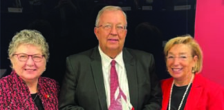 The University of Louisville Board of Trustees recognized John Smith (center) for his more than 36 years of service to the university. Smith, who recently retired as UofL's assistant director of intramural and recreational sports, served on UofL's Staff Senate (chair, 2018-2023) and as the staff representative on the Board of Trustees. Pictured with Smith are UofL President Kim Schatzel, left, and Board Chair Mary Nixon.