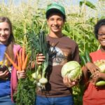 Mackenzie Williams, left, with her “house-sibling” Daylan and another ranch resident Paige on the farm where she was forced to work. (Photo by Mackenzie Williams)