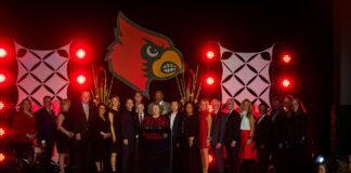 President Kim Schatzel on stage with honorees at the 2023 Alumni Awards.