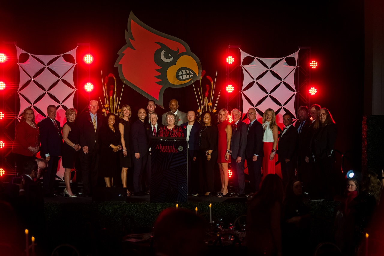 President Kim Schatzel on stage with honorees at the 2023 Alumni Awards.