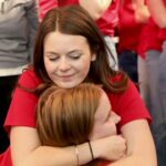 Students embrace as part of the 2024 raiseRED celebration.