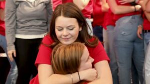 Students embrace as part of the 2024 raiseRED celebration. 