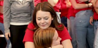 Students embrace as part of the 2024 raiseRED celebration.