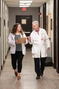 Caitlan Jones and William Crump, associate dean of Trover Campus at the UofL School of Medicine. Students can spend part of medical school in Madisonville, Ky. preparing to practice in a small community. UofL photo.