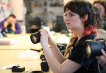 Canon brings industry expertise to mentor, support UofL’s graphic design students Student holds a Canon camera.