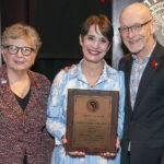 Professor Jennifer Brueckner-Collins, center, is the recipient of the 2024 University of Louisville Trustees Award. Pictured with her are Uofl President Kim Schatzel (left) and Provost Gerry Bradley (right).