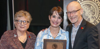 Professor Jennifer Brueckner-Collins, center, is the recipient of the 2024 University of Louisville Trustees Award. Pictured with her are Uofl President Kim Schatzel (left) and Provost Gerry Bradley (right).