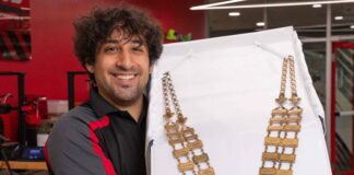 Luis Rodriguez 3D printed a lighter weight replica of the metal medallion necklace worn by UofL's president in commencement and other ceremonies. UofL photo by Ashly Cecil.