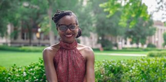 Tabitha Grier-Reed seated on a bench outside.