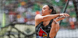 a woman throws the discus in a track and field competition