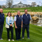 3 men and a woman on a golf course