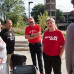 President Schatzel wears a red t-shirt and talks to new families.
