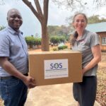 Rochelle Holm, UofL associate professor in the Christina Lee Brown Envirome Institute, and Petros Chigwechokha, head of the Department of Biological Sciences at Malawi University of Science and Technology, received a shipment of medical and research supplies thanks to SOS International in Louisville.