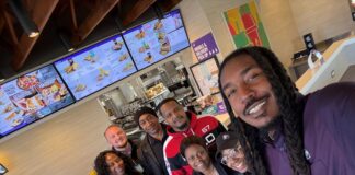 Ethan McNary at a Taco Bell restaurant with team members