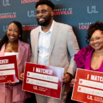 UofL medical students hold signs announcing their residency program placements.