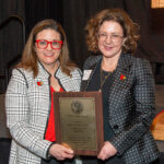 Jasmine Farrier, right, accepts the 2025 UofL Trustees Award from Interim University Provost Katie Cardarelli.