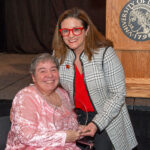 Linda Leake, left, is presented with UofL's George J. Howe Distinguished Staff Award by UofL Interim Provost Katie Cardarelli.