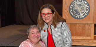 Linda Leake, left, is presented with UofL's George J. Howe Distinguished Staff Award by UofL Interim Provost Katie Cardarelli.