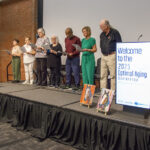 Older adults singing on stage.