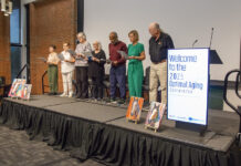 Older adults singing on stage.