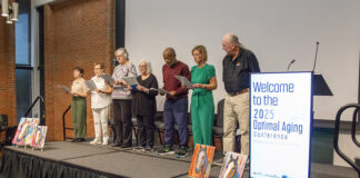 Older adults singing on stage.