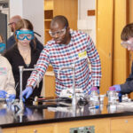 Students work on a chemistry experiment in a lab