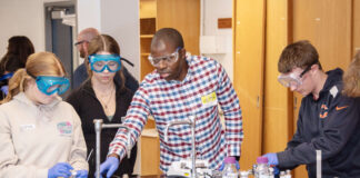 Students work on a chemistry experiment in a lab