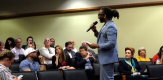 Man talks with an audience