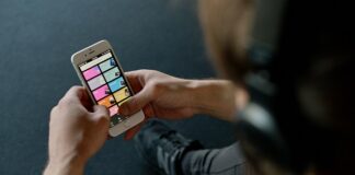 Person listening to a smartphone playlist.