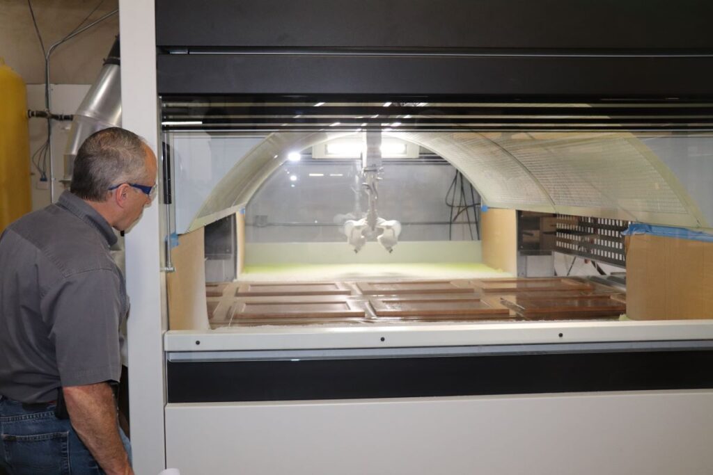 Man watching doors in sprayer machine