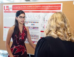 Student demonstrates her poster 