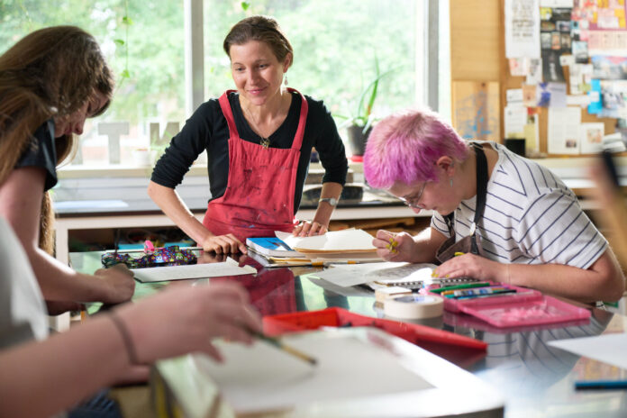 Rachel Singel, associate professor teaching a printmaking studio course