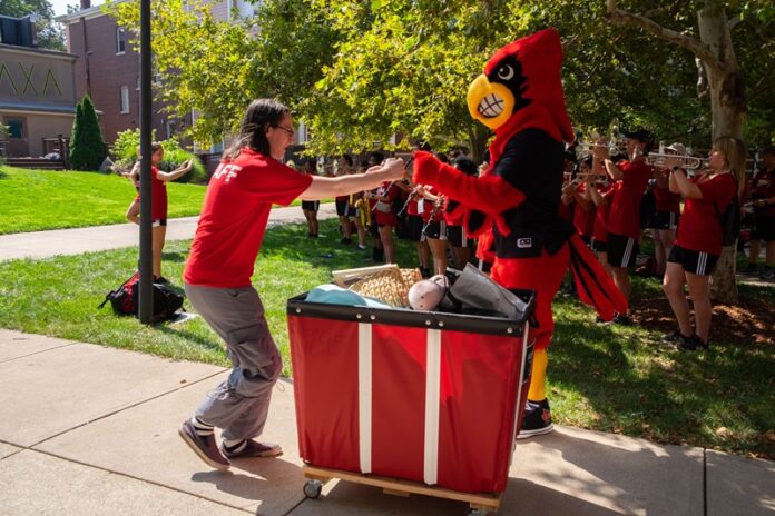 Louie greets those helping with Move-In.