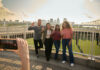 Students throwing up their L's for a group photo opportunity at the Big Four Bridge at Waterfront Park in downtown Louisville.
