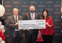 UofL Executive Vice President of Health Affairs Jeffrey Bumpous and UofL Health Interim CEO Jason Smith were presented with a check from the WHAS Crusade for Children President and CEO Dawn Lee on Sept. 17, 2025.