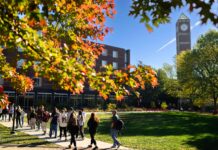 Students walking across campus in the fall.