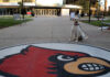 Lily, the ULPD comfort dog sits next to the Cardinal outside of BAB